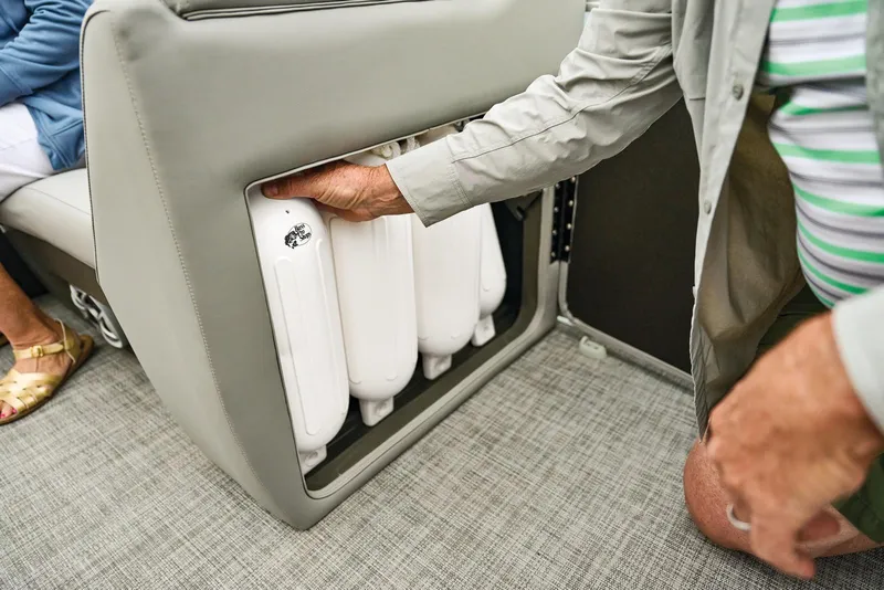 Slide: The Image of Manufacturer Provided Image: Person accessing storage compartment on 2026 Sun Tracker SportFish 22 DLX boat. - 76