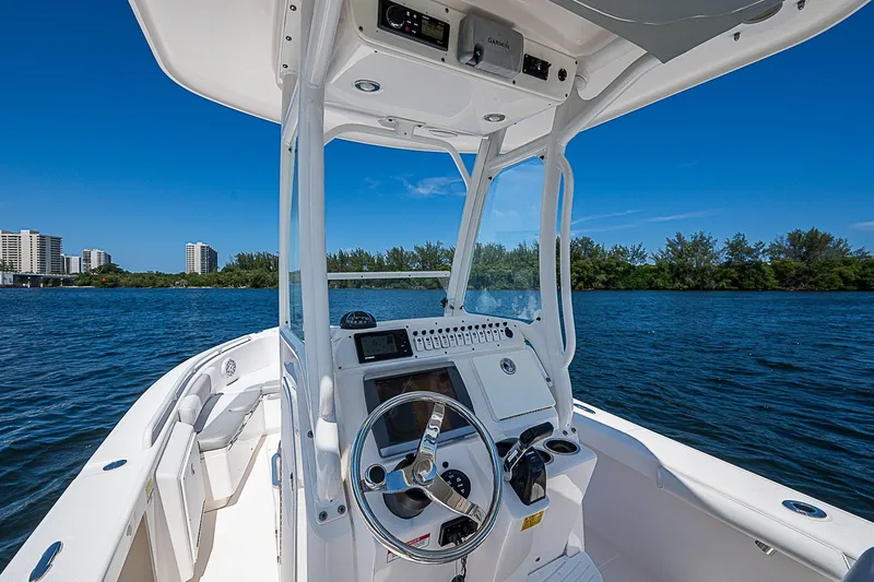 Slide: The Image of 2012 Everglades 243 Center Console boat on water, clear sky, cityscape in background. - 19