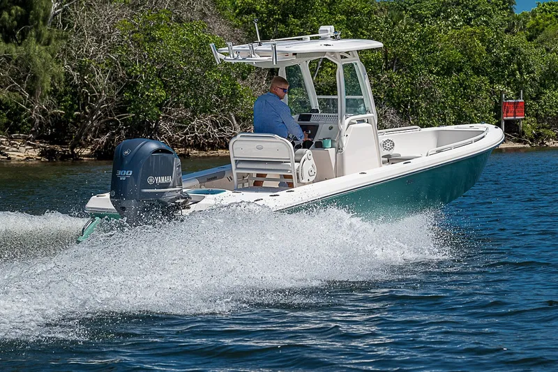 Slide: The Image of 2012 Everglades 243 Center Console boat cruising on water with Yamaha engine. - 48