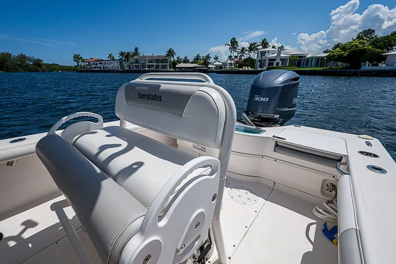 Slide: The Image of 2012 Everglades 243 Center Console boat on water, featuring a powerful outboard motor. - 21