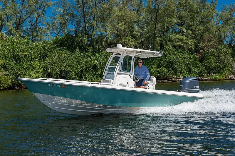 Slide: The Image of 2012 Everglades 243 Center Console boat cruising on a scenic waterway. - 56