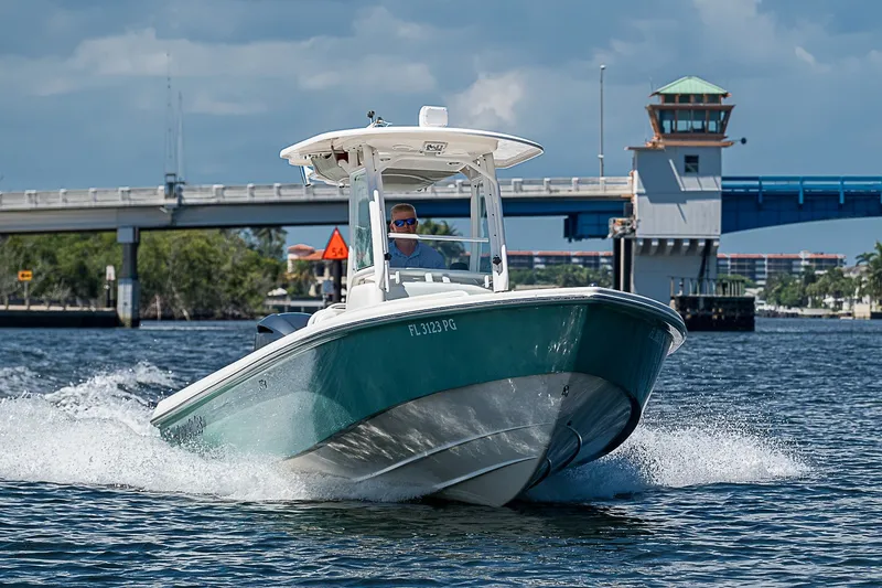 Slide: The Image of 2012 Everglades 243 Center Console boat cruising near a bridge on a sunny day. - 42
