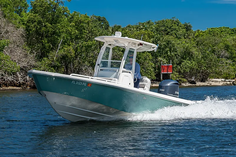 Slide: The Image of 2012 Everglades 243 Center Console boat cruising on a scenic waterway. - 53