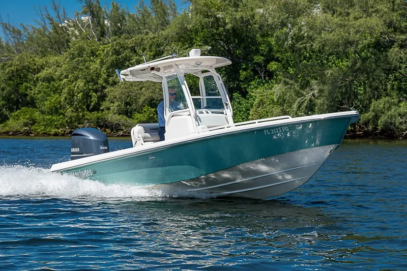 Slide: The Image of 2012 Everglades 243 Center Console boat cruising on a scenic waterway. - 44