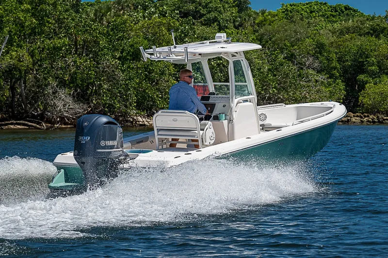 Slide: The Image of 2012 Everglades 243 Center Console boat cruising on water with Yamaha engine. - 49