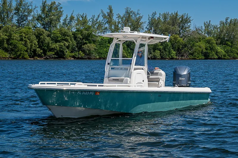 Slide: The Image of 2012 Everglades 243 Center Console boat cruising on a scenic lake. - 26