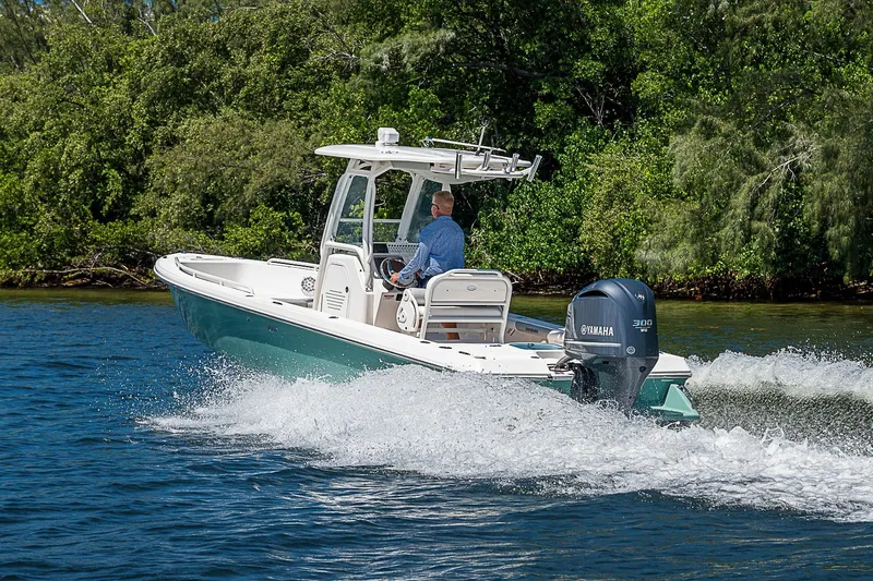 Slide: The Image of 2012 Everglades 243 Center Console boat cruising on a scenic waterway. - 59