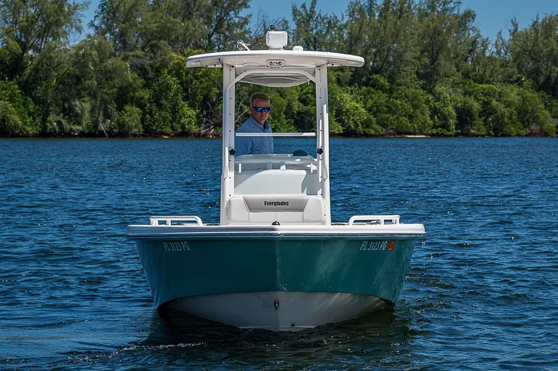 Slide: The Image of 2012 Everglades 243 Center Console boat on water, surrounded by lush greenery. - 28