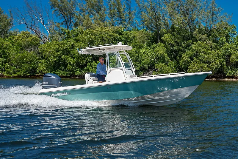 Slide: The Image of 2012 Everglades 243 Center Console boat cruising on a scenic waterway. - 45