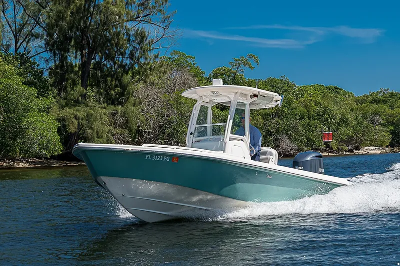 Slide: The Image of 2012 Everglades 243 Center Console boat cruising on a scenic waterway. - 54