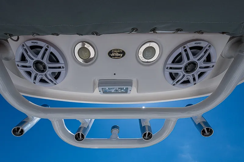 Slide: The Image of 2012 Everglades 243 Center Console boat speakers and rod holders against blue sky. - 20