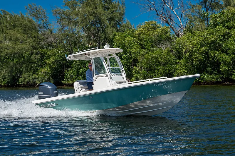 The Image of 2012 Everglades 243 Center Console boat cruising on a scenic waterway. - 1