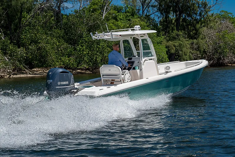 Slide: The Image of 2012 Everglades 243 Center Console boat cruising on water with Yamaha engine. - 47