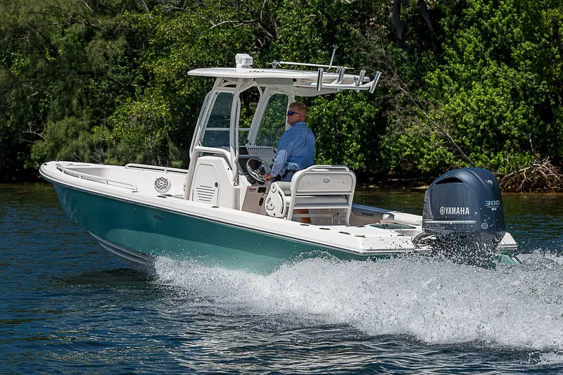 Slide: The Image of 2012 Everglades 243 Center Console boat cruising on water with Yamaha engine. - 58