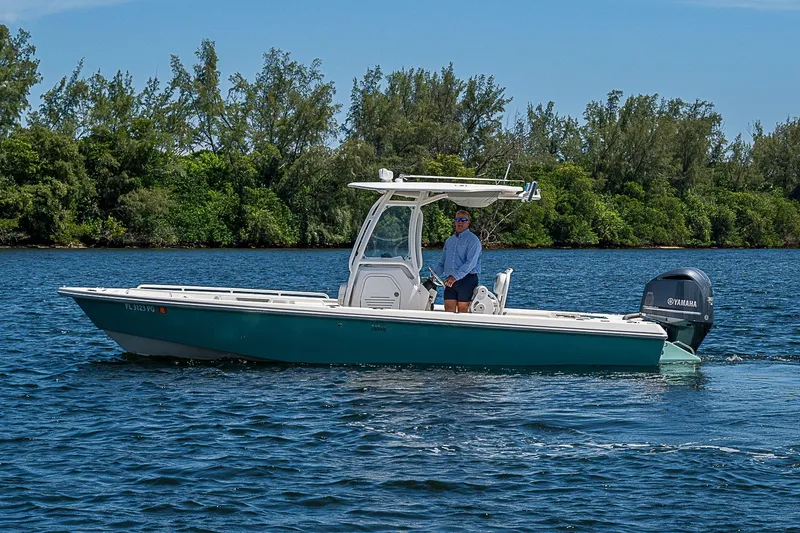 Slide: The Image of 2012 Everglades 243 Center Console boat cruising on a scenic waterway. - 40