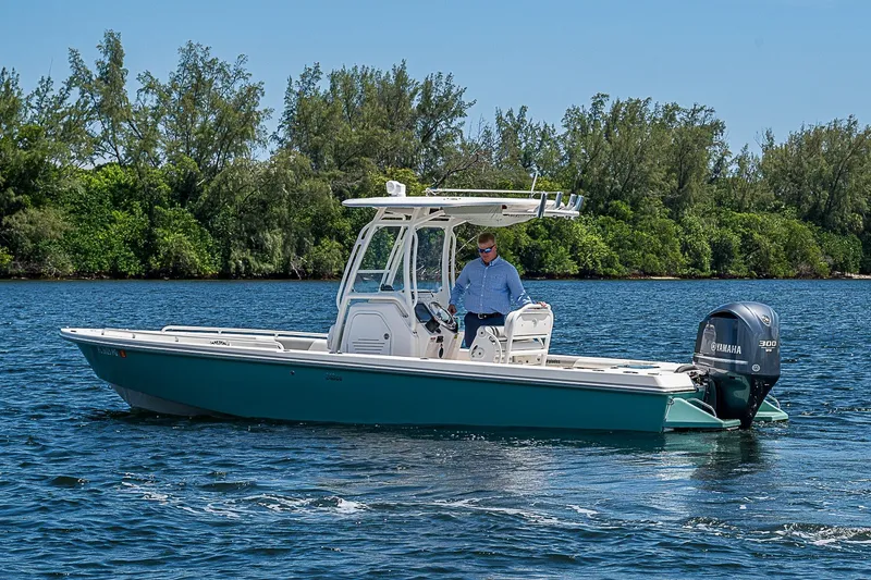 Slide: The Image of 2012 Everglades 243 Center Console boat cruising on a scenic waterway. - 39