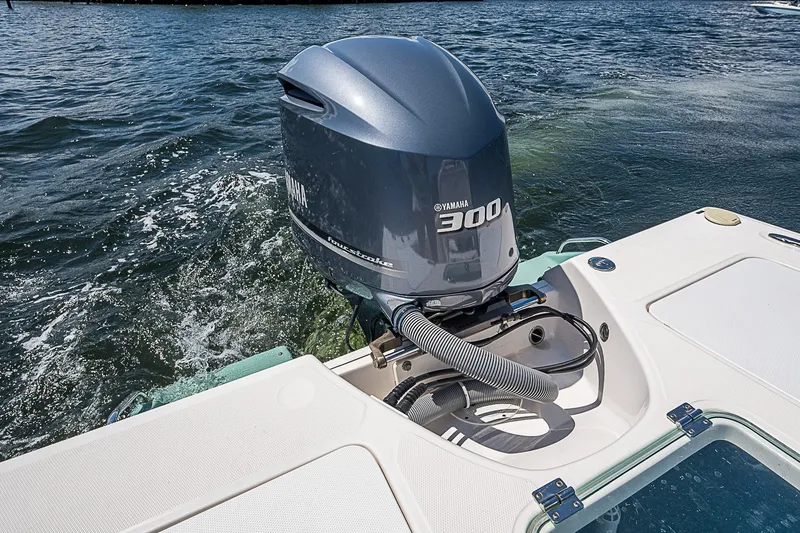 Slide: The Image of Outboard motor on 2012 Everglades 243 Center Console boat in water. - 14