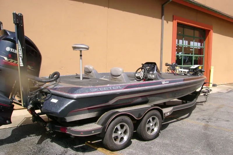 Slide: The Image of 2016 Skeeter ZX225 bass boat with Yamaha engine, parked on a trailer. - 6