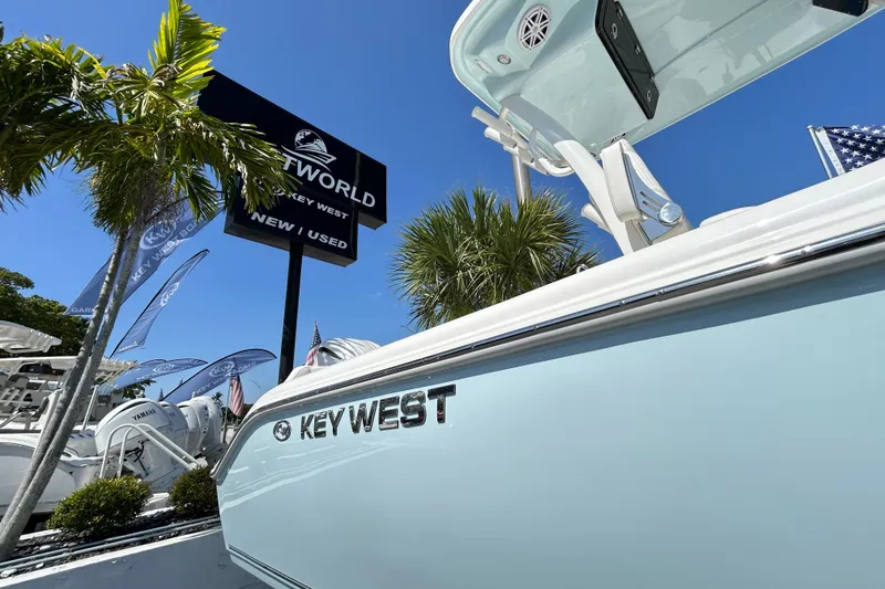 Slide: The Image of 2026 Key West 249 FS boat displayed at a dealership under clear blue skies. - 1