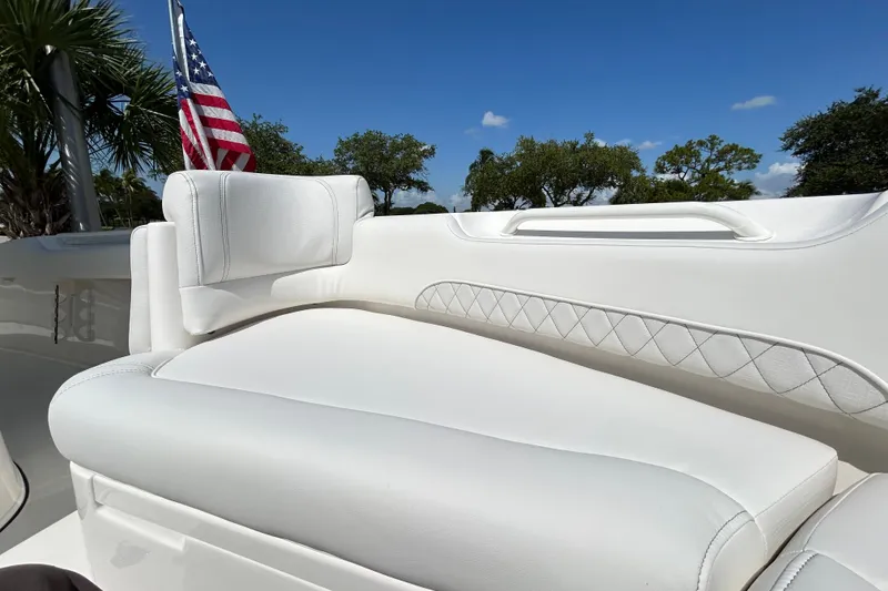 Slide: The Image of 2026 Key West 249 FS boat interior with white seating and American flag in the background. - 8