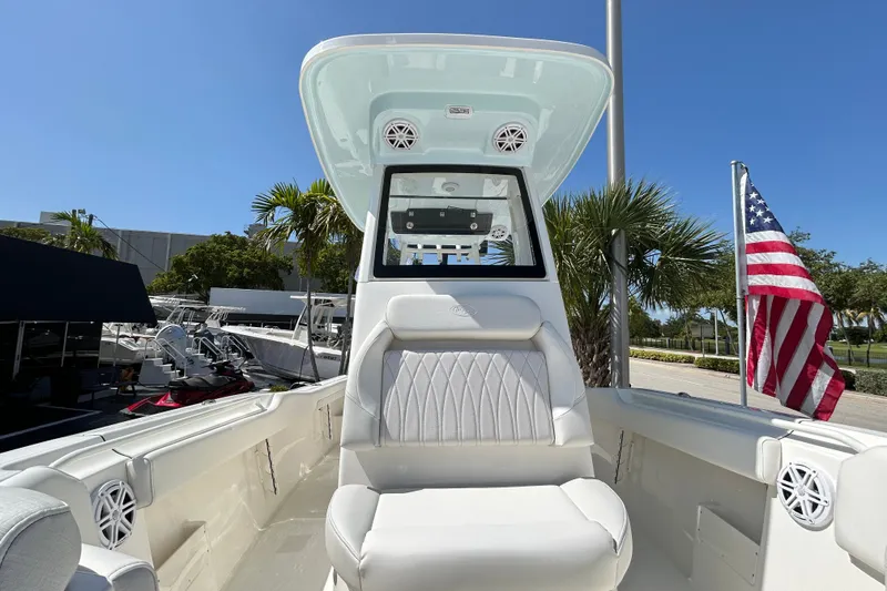 Slide: The Image of 2026 Key West 249 FS boat interior with American flag, palm trees, and clear blue sky. - 9