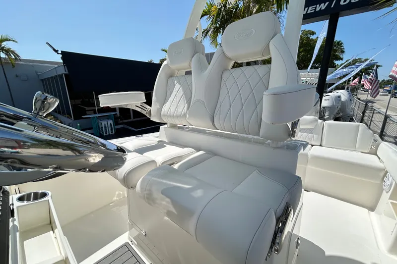 Slide: The Image of 2026 Key West 249 FS boat interior with luxurious white seating and chrome accents. - 13