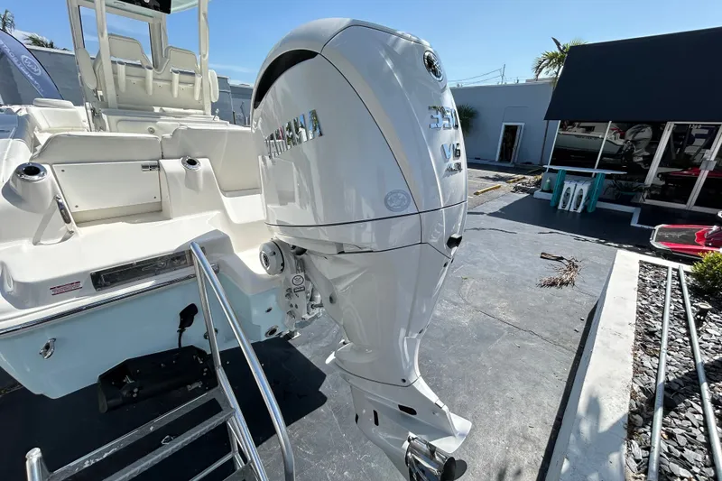 Slide: The Image of 2026 Key West 249 FS boat with Yamaha V6 outboard motor in a sunny marina. - 24