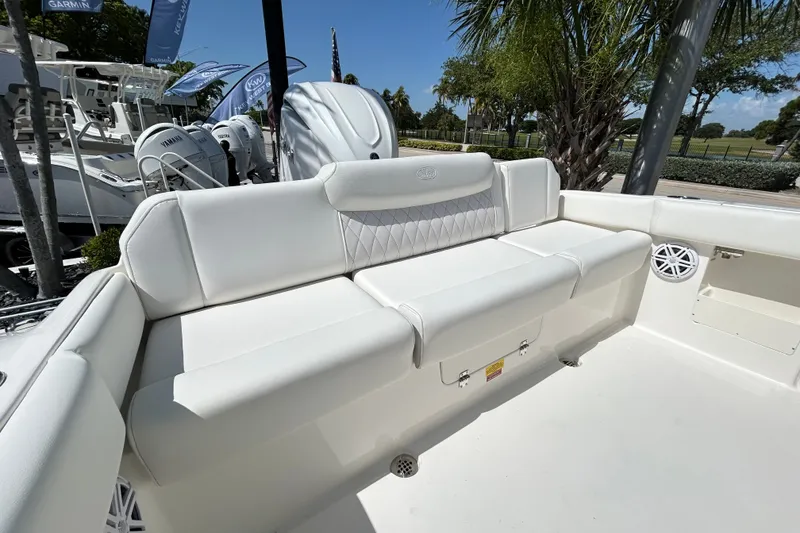 Slide: The Image of 2026 Key West 249 FS boat interior with white cushioned seating and outdoor setting. - 21