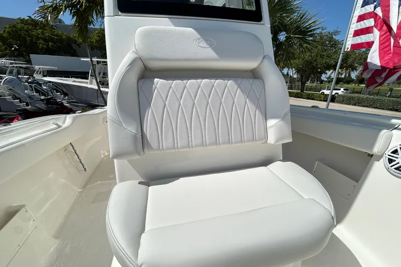 Slide: The Image of 2026 Key West 249 FS boat seat with white upholstery and American flag in background. - 10