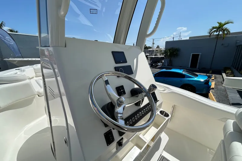 Slide: The Image of 2026 Key West 249 FS boat helm with steering wheel and control panel. - 16