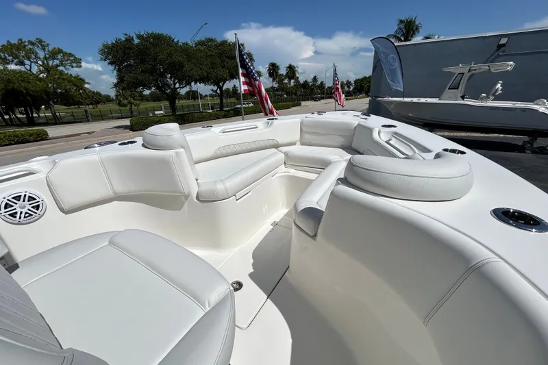 Slide: The Image of 2026 Key West 249 FS boat interior with white seating and American flags. - 4