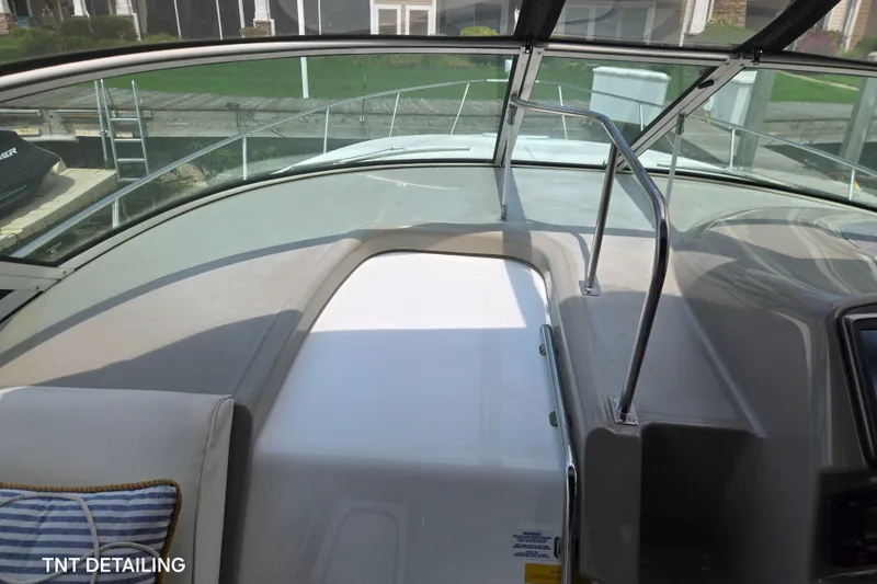 Slide: The Image of 2001 Cruisers Yachts 3470 Express cockpit with windshield and seating area. - 5