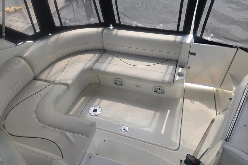 Slide: The Image of 2001 Cruisers Yachts 3470 Express interior with beige seating and cup holders. - 7