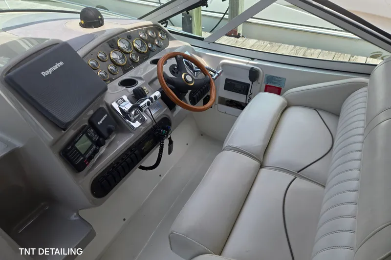Slide: The Image of 2001 Cruisers Yachts 3470 Express helm with leather seating and Raymarine electronics. - 4
