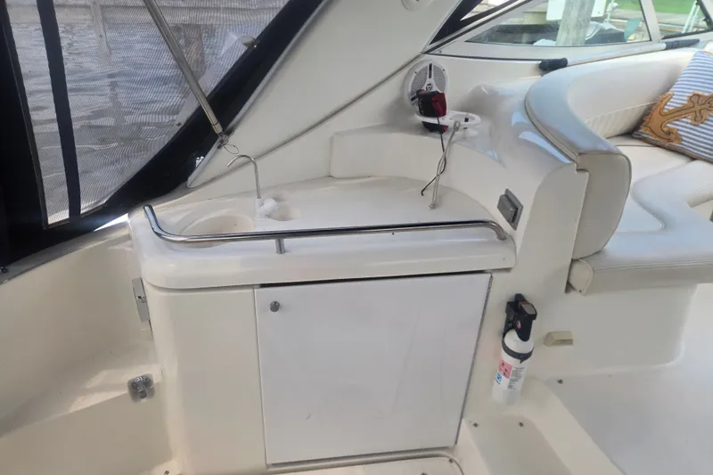 Slide: The Image of 2001 Cruisers Yachts 3470 Express interior with sink, seating, and fire extinguisher. - 8