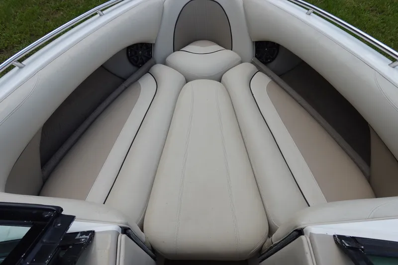 Slide: The Image of Interior seating of a 2000 Malibu Wakesetter 23 LSV boat, featuring beige upholstery. - 16