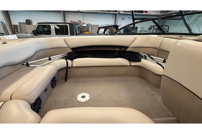 Slide: The Image of Interior of 2000 Malibu Wakesetter 23 LSV boat with beige seating and storage. - 23