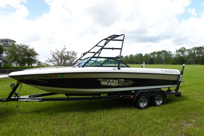 The Image of 2000 Malibu Wakesetter 23 LSV boat on trailer in grassy field. - 1