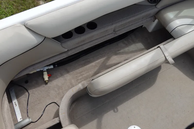 Slide: The Image of Interior view of a 2000 Malibu Wakesetter 23 LSV boat, showcasing seating and storage area. - 11