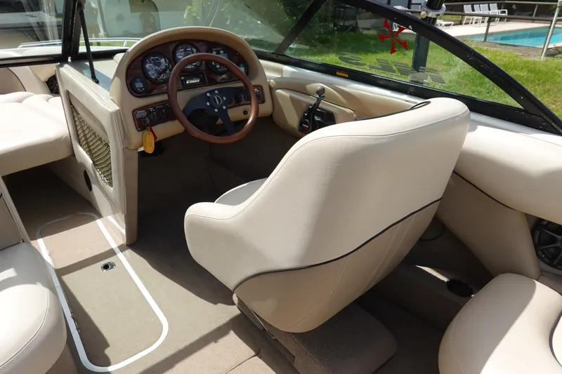 Slide: The Image of Interior of a 2000 Malibu Wakesetter 23 LSV boat with beige seating and dashboard. - 6