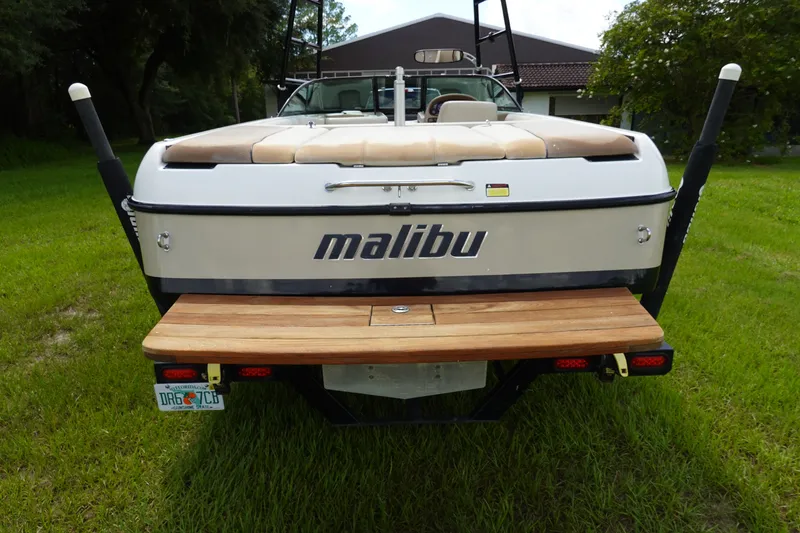 Slide: The Image of Rear view of a 2000 Malibu Wakesetter 23 LSV boat on grass. - 2