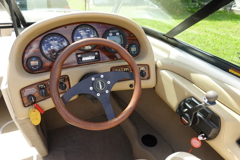 Slide: The Image of Interior dashboard of a 2000 Malibu Wakesetter 23 LSV boat with wooden steering wheel. - 7