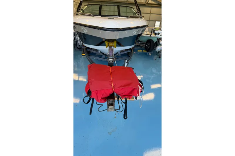 Slide: The Image of 2000 Malibu Wakesetter 23 LSV boat on trailer with red cover in garage. - 22