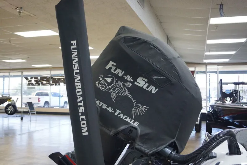 Slide: The Image of 2023 Skeeter ZXR21 boat engine cover with Fun-N-Sun branding in showroom. - 21