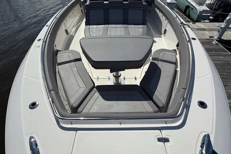 Slide: The Image of 2024 Boston Whaler 420 Outrage boat with spacious seating and table on deck. - 49