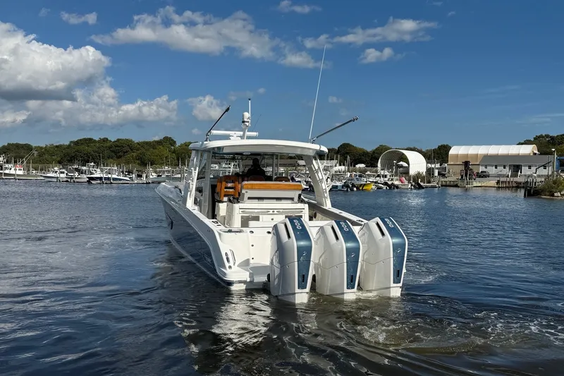 Slide: The Image of 2024 Boston Whaler 420 Outrage boat with four engines on a sunny day. - 7