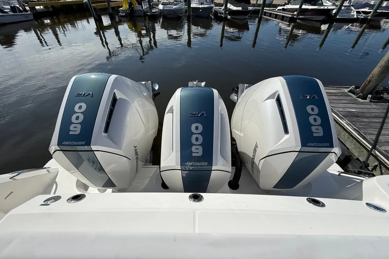 Slide: The Image of Triple Mercury 600 V12 engines on a 2024 Boston Whaler 420 Outrage at a marina. - 9