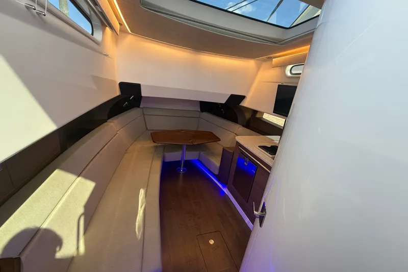 Slide: The Image of Luxurious interior of 2024 Boston Whaler 420 Outrage with elegant seating and ambient lighting. - 38