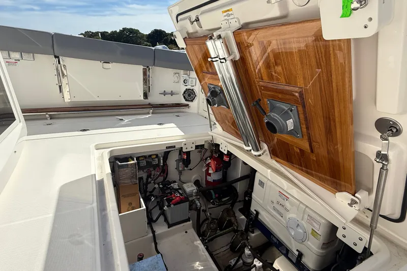 Slide: The Image of 2024 Boston Whaler 420 Outrage boat interior, showcasing storage and mechanical compartments. - 14