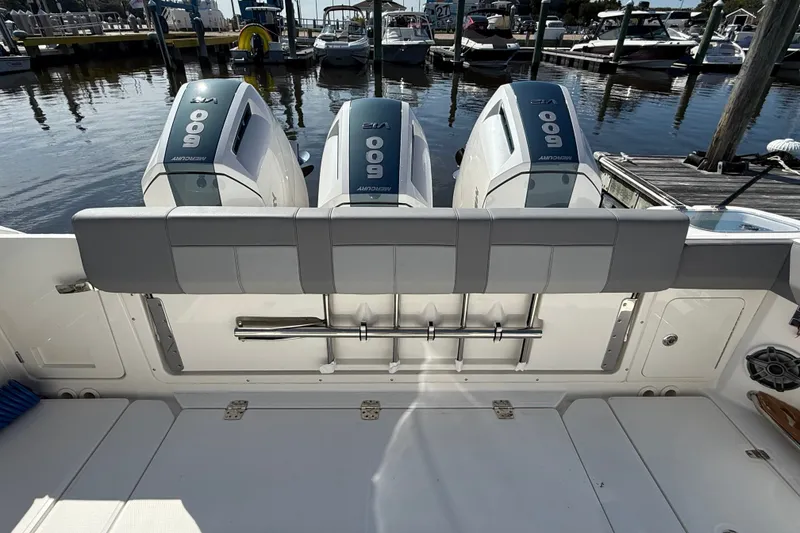 Slide: The Image of 2024 Boston Whaler 420 Outrage with triple Mercury 600 engines at marina dock. - 11